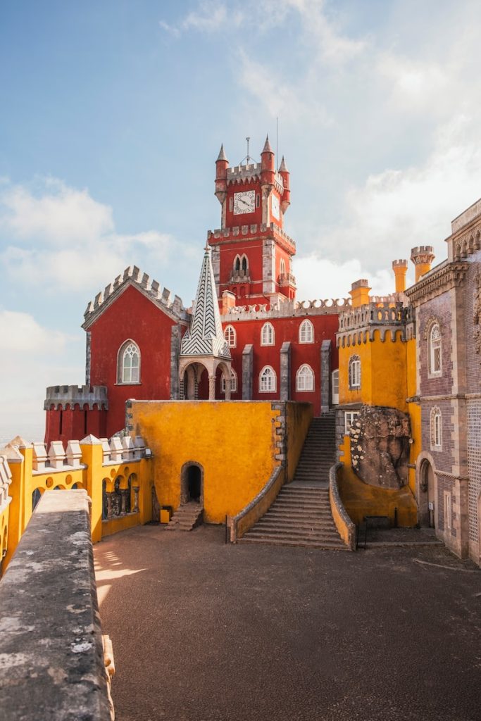 Lisbon 3 day itinerary: yellow and red concrete building under clear blue sky