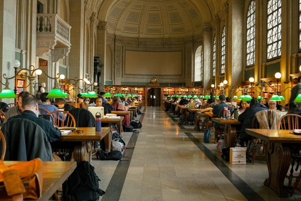 a group of people sitting at tables in a large room